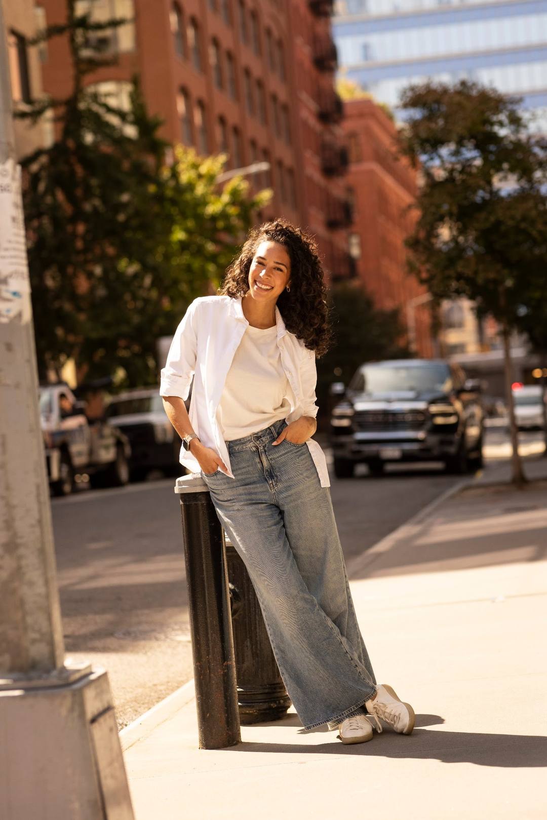 A woman in a white shirt on a city street